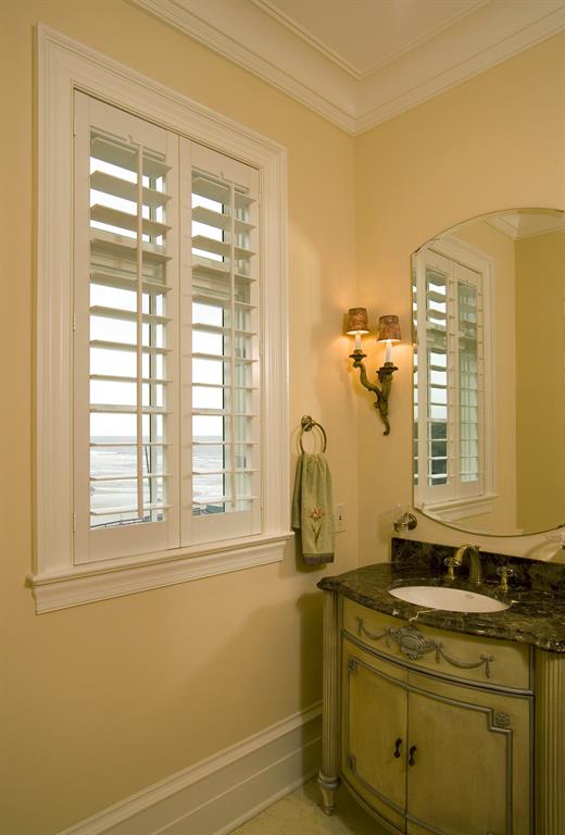 Plantation shutters in a bathroom outlooking the ocean